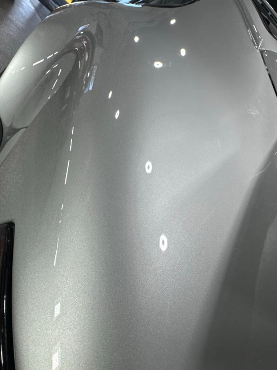 Deep gloss ceramic coating result showing mirror-like reflection on vehicle paint