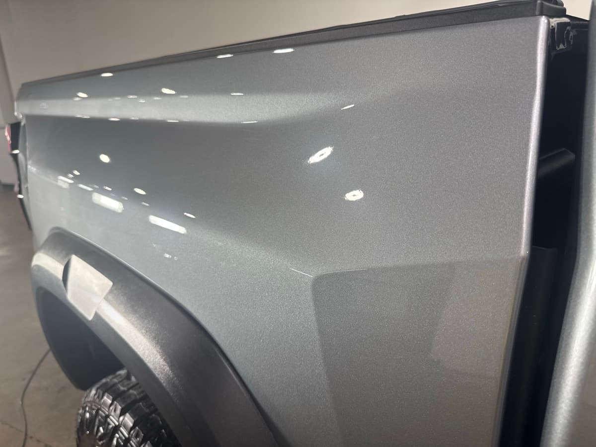 Factory finish preservation with paint protection film on new vehicle