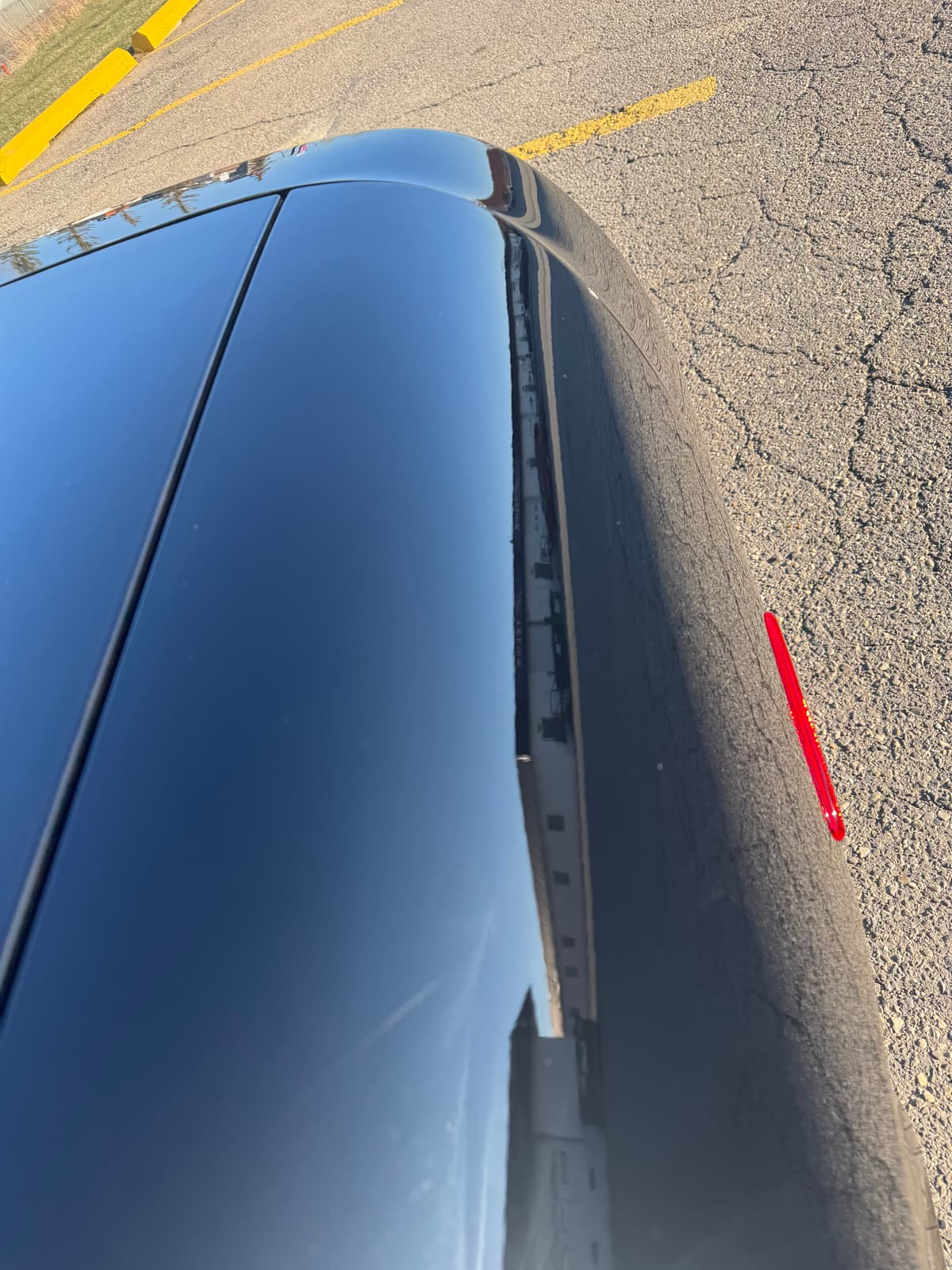 Black vehicle paint with deep mirror-finish reflection after multi-stage paint correction at 2Clean Inc. Calgary